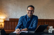 © bnenin - Smiling adult man working at the office, taking notes, making plans.