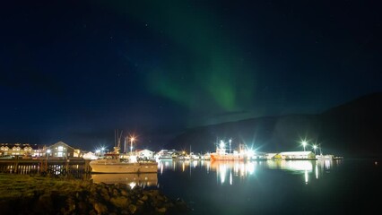 Wall Mural - icelandic fishing town aurora borealis over harbor boats at dusk