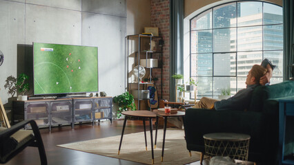 Sports Fan Watches Important Soccer Match on TV at Home, He Aggressively Gestures with the Fist, Cheering for His Favourite Team. His Successful Team Scores a Goal and He Celebrates the Win.