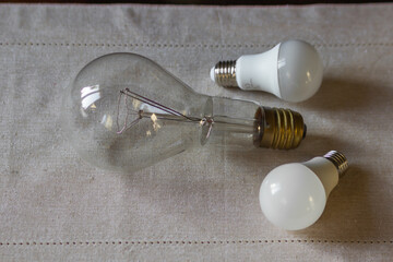 Set of two LED light bulbs and big electric light bulb. Energy saving concept, alternative eco sources. Blackout.