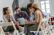 © BalanceFormCreative - Group of casually dressed coworkers discussing ideas at the office about a new startup project.