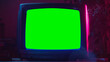 canvas print picture - Close Up Footage of a Dated TV Set with Green Screen Mock Up Chroma Key Template Display. Nostalgic Retro Nineties Technology Concept. Vintage Television Display in Neon Lit Living Room.