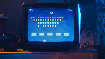 Close Up Footage of a Retro TV Set Screen with an 8 Bit 2D Eighties Inspired Console Arcade Video Game. Nostalgic Shooter Game, Player Battle with Swarm of Aliens and Wins the Hardest Level.