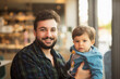 © Antonio Recena - Bearded man with baby son in bar near to window looking at camera