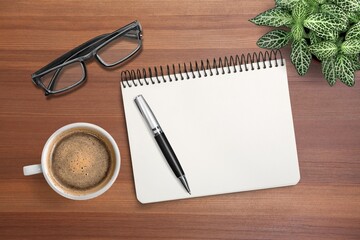 Wall Mural - Blank office notebook with pen and cup on the desk