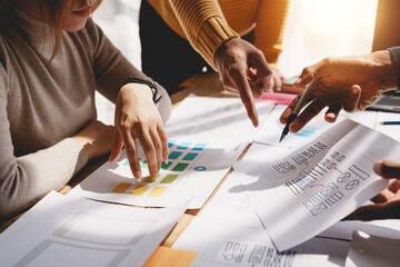 Wall Mural - ux ui designers come up with new ideas at a meeting to present in office mobile internet software la