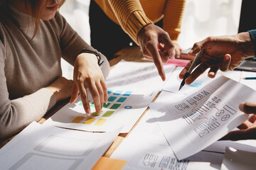 Wall Mural - ux ui designers come up with new ideas at a meeting to present in office mobile internet software la