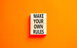 Make your own rules symbol. Concept words Make your own rules on wooden cubes. Beautiful orange table orange background. Business motivational make your own rules concept. Copy space