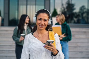 Wall Mural - Front view of a college student with headphones