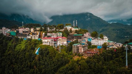 Canvas Print - Colorful buildings on the peak of mountains over the dense rainy clouds, Himachal Pradesh India