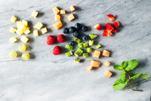 Overhead View Of Various Fruit Slices On Marble Counter