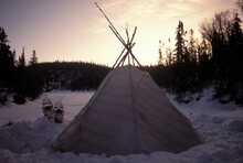 Winter Sunset Over A Teepee In Snow.