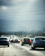 Defocused Rear View Of Automobile Traffic On A Interstate Highway In California, USA.