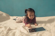 © Cavan Images - little girl playing tablet pc
