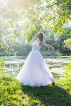 View Of A Beautiful Bride Dancing By Lake, Germany