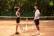 © zinkevych - Two young people having a workout at tennis court