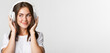 © Mix and Match Studio - Close-up of smiling attractive brunette girl listening music in headphones, enjoying interesting podcast