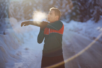 Male runner warming up at winter time