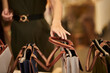 © DragonImages - Woman Choosing New Purse