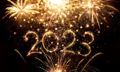 Wall Mural - 2023 New Year Celebration - Glitter On Golden Numbers With Sparkler And Fireworks In Black - Abstract Defocused Lights
