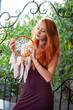 Portrait of lovely slim redhead girl in wine dress and dreamcatcher craft talisman