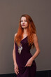 Portrait of lovely slim redhead girl in wine dress and dreamcatcher craft talisman