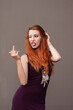 Beautiful provocative redhead girl showing middle finger