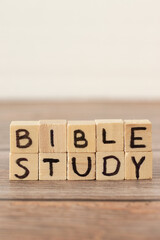 Bible study handwritten text on wood cubes on rustic table with white background. Copy space. Vertical shot, a closeup. 