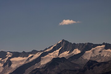 Sticker - Beautiful Grosvenediger snow-capped mountain against the blue sky with a floating cloud