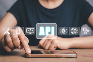 API - Application Programming Interface, Woman touching on smartphone with VR screen API icon on office desk, Software development tool, modern technology, internet and networking concept.