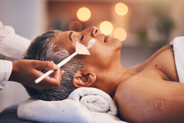 Spa, facial and senior black woman with mask for skincare, beauty and luxury treatment at beauty salon. Wellness, face massage and mature female relax on holiday, vacation and retirement at resort