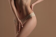 © Mirrorstudio - Thin young woman in underwear on beige background