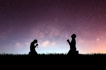 Wall Mural - Man praying with hope against Milky Way background