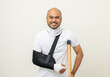 © Chanakon - Happy young asian man broken arm and leg on isolated. Man put on plaster cast splint with walking sticks crutches. Patient wearing sling support arm with neck collar. life insurance and accident