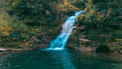 Canvas Print - Splashing water of the beautiful waterfall in the green park