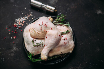 raw chicken legs on a dark background
