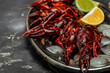 © Надія Коваль - boiled crayfish on a metal tray, on a dark background. beer appetizer, banner, menu, recipe place for text, top view