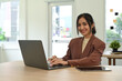 © Prathankarnpap - Beautiful asian female investor working online, analyzing financial online data on laptop computer