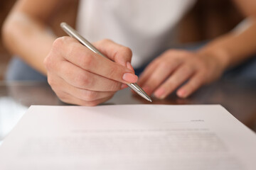 Wall Mural - Woman signs contract or agreement close-up.