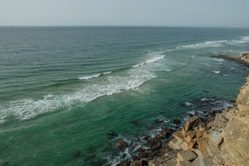 Wall Mural - ocean waves approaching rocky shore. top view. beautiful nature background.