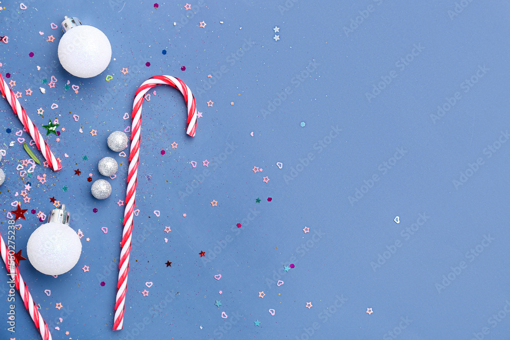 Composition with tasty candy canes and Christmas decor on color background