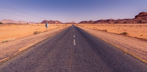 Poster - Empty highway through the desert under the blue sky