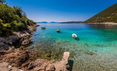 Canvas Print - Scenic view of the sea with boats and coastline mountain forests under the blue sky