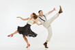 © master1305 - Young excited man and woman in 60s american fashion style clothes dancing retro dance isolated on white background. Music, energy, happiness, mood, action