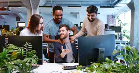 multiethnic team of males and female cooperating in coworking space. it team of developers working, 