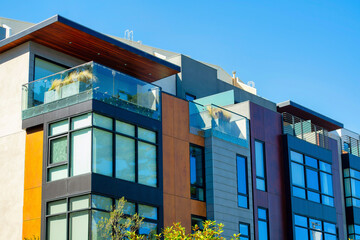 Luxury downtown apartment buildings with decorative exterior and blue and white gradient sky background in late afternoon shade