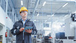 © Gorodenkoff - Portrait of a Young Asian Man, Working as an Engineer at a Factory Facility, Wearing Work Jacket, Safety Glasses, and a Yellow Hard Hat. Heavy Industry Specialist Working on Tablet Computer.