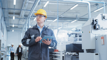 Aufkleber - Portrait of a Young Asian Man, Working as an Engineer at a Factory Facility, Wearing Work Jacket, Safety Glasses, and a Yellow Hard Hat. Heavy Industry Specialist Working on Tablet Computer.