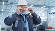 © Gorodenkoff - Portrait of a Middle Aged, Successful Male Engineer Putting On a White Hard Hat and Safety Glasses, While Walking at Electronics Manufacturing Factory. Heavy Industry Specialist Posing for Camera.
