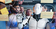 © ihorvsn - Team of startup planning future tasks in office with humanoid. People and artificial intelligence discussing work and project. Brainstorming meeting. Management strategy. Digital transformation